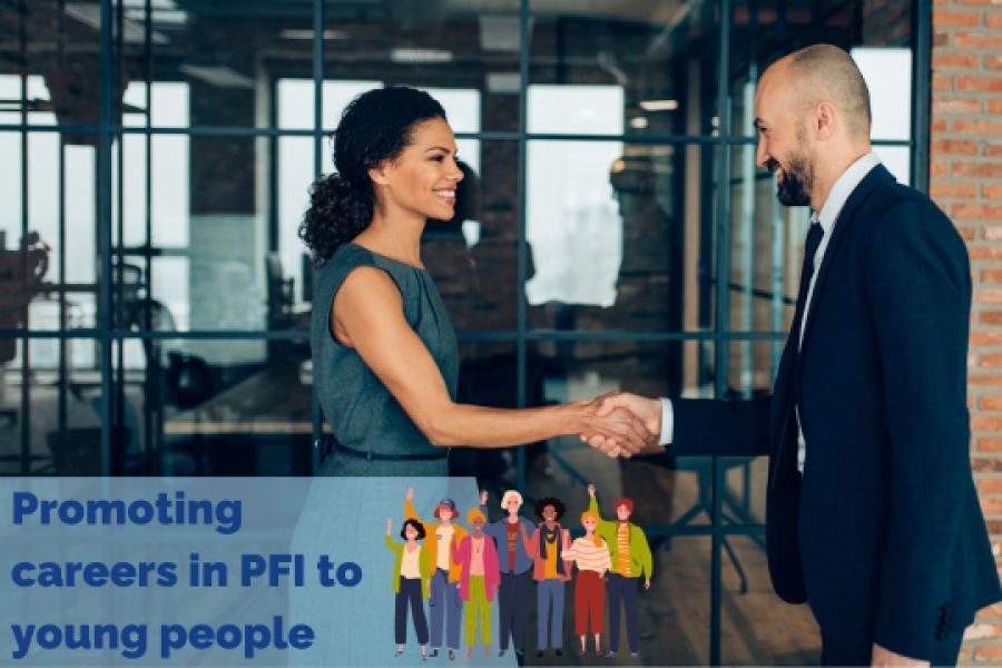 A male and female professional shake hands whilst wearing smart clothing in a industrial chic room with exposed brick and a large window.